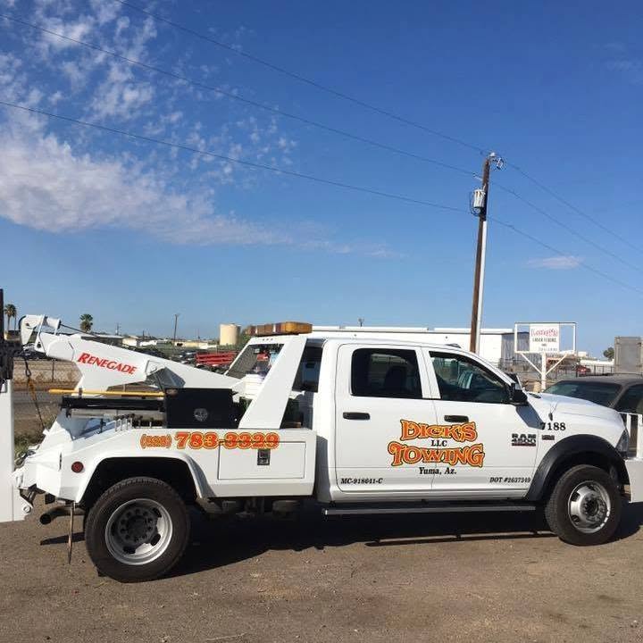 A Dick's Towing wrecker parked at the Yuma yard under a clear blue sky.